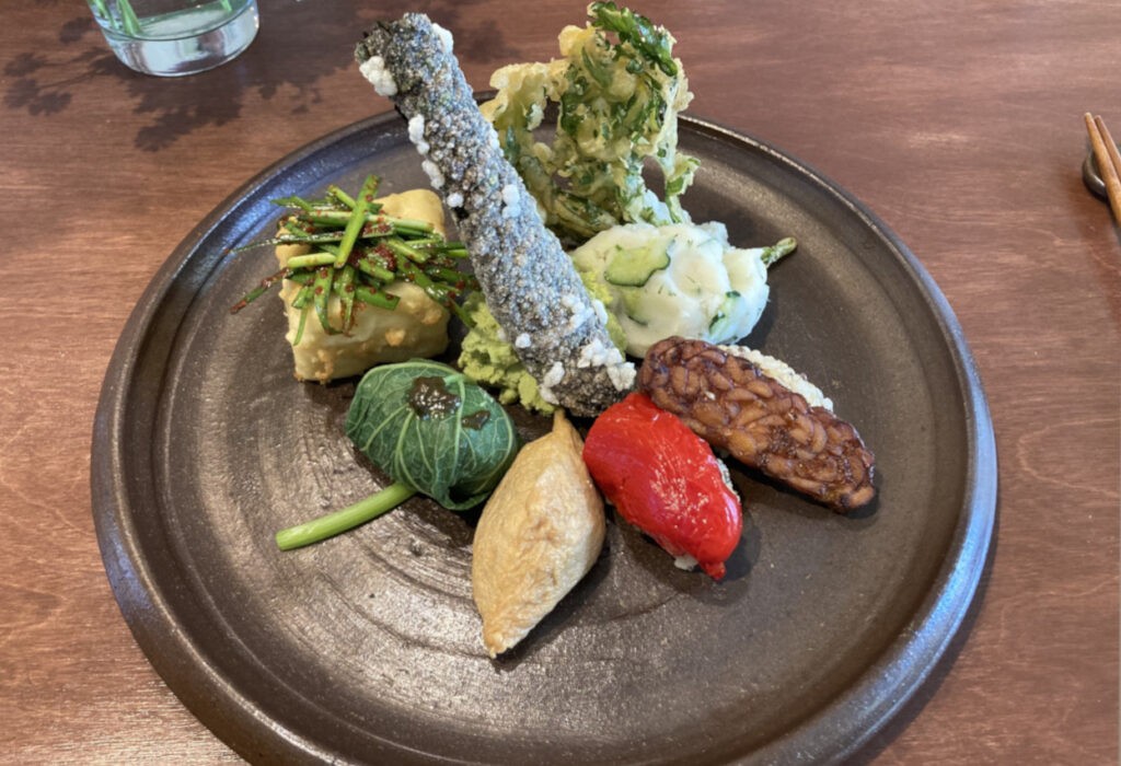 Vegan sushi with veggie fries and salad in Santosha